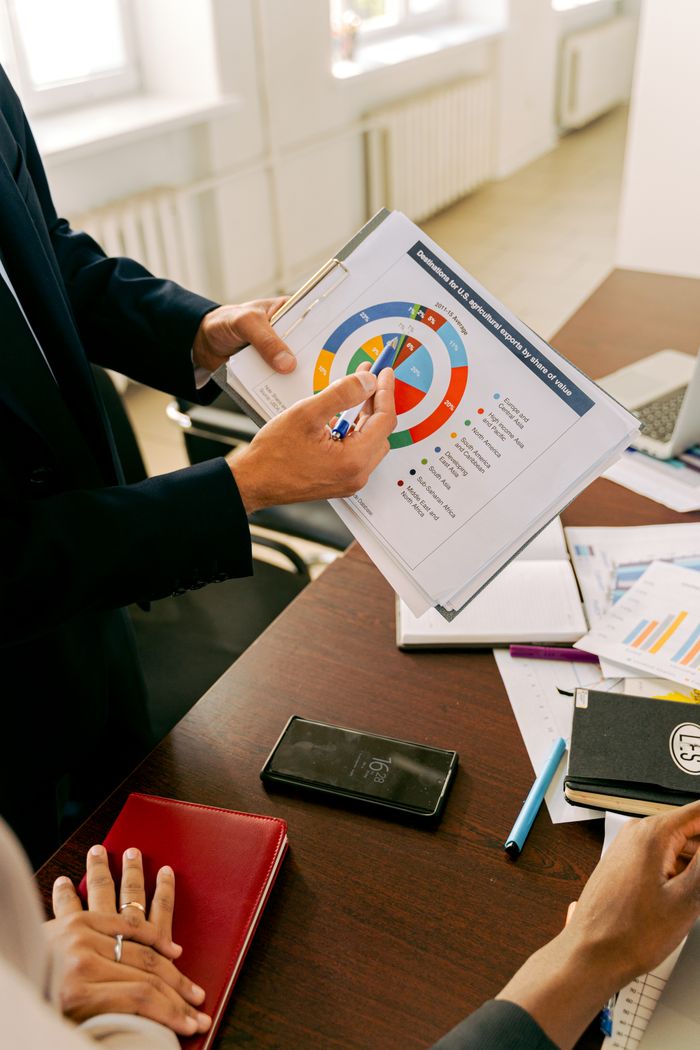 hero-img Business professionals discussing financial charts during a strategy meeting.